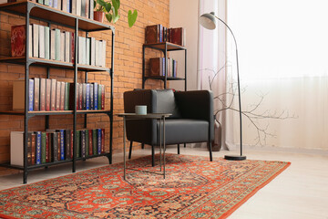Interior of cozy living room with vintage carpet, armchair and bookcases