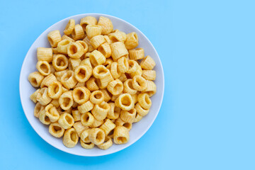 Crispy potato rings on blue background.