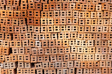 Stack of red bricks, orange clay bricks