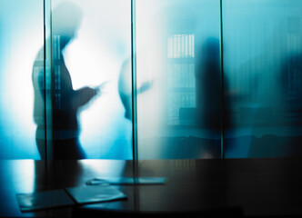 The unseen work is often the most important. Cropped shot of an unrecognizable businessmans silhouette against a glass wall in his office.
