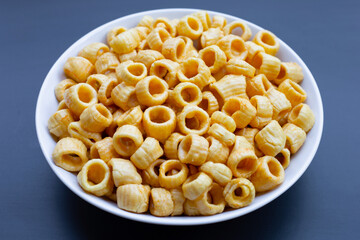 Crispy potato rings on dark background.