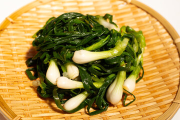 Pickled spring onion on bamboo plat