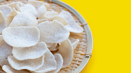 Prawn crackers on yellow background. Shrimp crispy rice snack