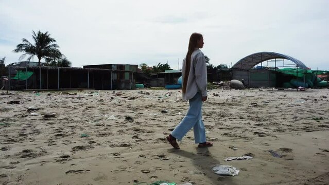 European Girl Walking On The Mui Ne Beach With Round Boats In The Shore At Summer In Vietnam. - panning