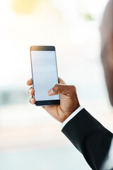 All his info in one place. Closeup shot of an unrecognizable businessman using a cellphone in an office.
