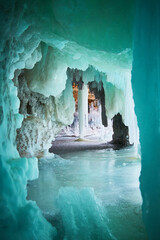 Large icicle in ice cave with vibrant blue and green colors