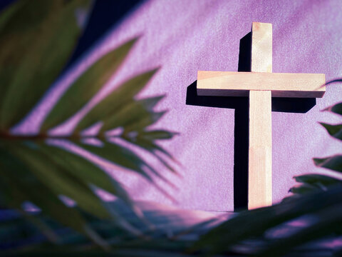 Lent Season,Holy Week and Good Friday concepts - image of wooden cross in purple vintage background. Stock photo.