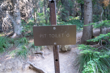 Sign leading hikers to the pit toilet, taken in Glacier National Park