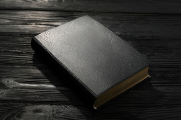 Bible on black wooden table. Christian religious book