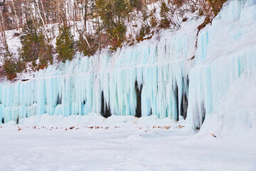 Wall of beautiful blue icicles and walls of ice