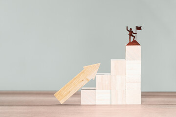 Wooden cube block with leader or winner or businessman icon and wood arrow up, Business growth and goal in next year concept.