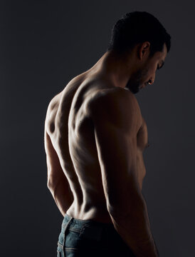 I work every muscle in the gym. Shot of a handsome young man standing alone and posing shirtless in the studio.