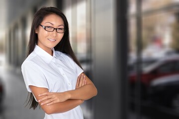 Beauty businesswoman standing in front of a high key office looking at the camera