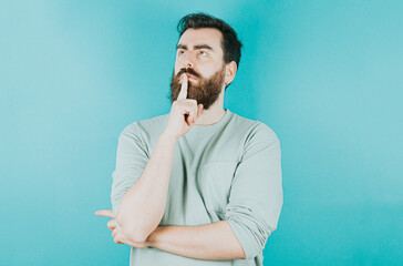 Handsome hipster bearded thinking something and trying to find a solution. Young man attitude...