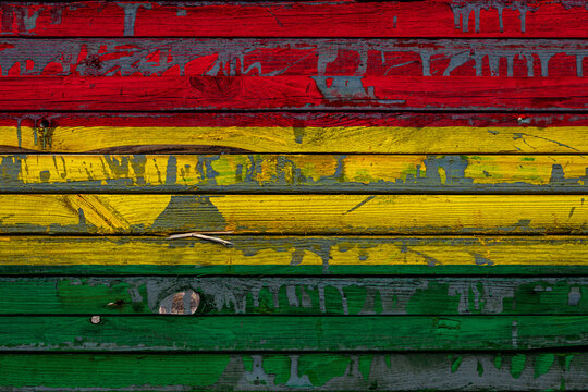 The national flag of Bolivia is painted on uneven boards. Country symbol.