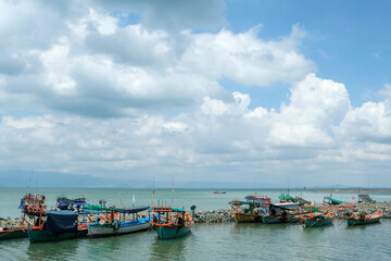 Kep, Cambodia - February 2022: Fishing boats on Kep beach on February 15, 2022 in Kep, Cambodia.