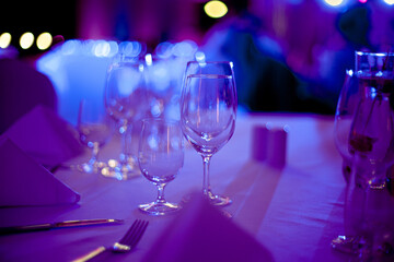 Wine glasses in the restaurant. Soft blue light and depth of field create an amazing atmosphere