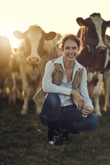 Farming is more than a job, its a lifestyle. Portrait of a happy female farmer posing in front of her herd of cattle. © Jadon Bester/peopleimages.com