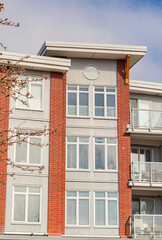 Brand new apartment building on sunny day in BC, Canada. Architectural details of modern apartment building