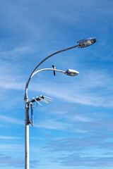 The upper part of the street lighting support with video surveillance equipment on a sunny day