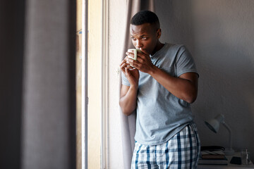 Theres nothing like coffee to get me through the day. Cropped shot of a handsome young man standing...