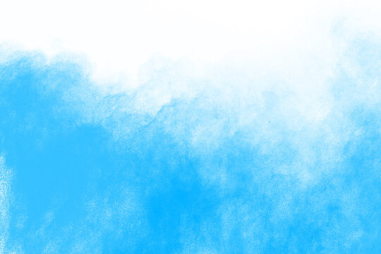 Powder explosion. Closeup of a blue dust particle explosion isolated on white. Abstract background © kitsana