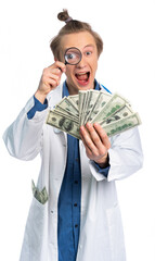 a young guy in a medical gown holds dollars and examines them through a magnifying glass. opened his mouth with delight. focus on money. crazy doctor