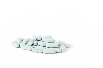 Fototapeta na wymiar a handful of blue pills on a white background