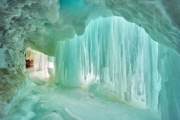 Large sheet of blue icicles inside of ice cavern