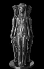 Ancient bronze sculpture The Three Nymphs. Three Graces isolated on black background with clipping path