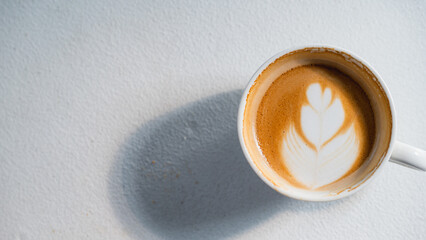 Cup of coffee latte on white table at coffee shop in morning time . Top view. Copy space.Coffee latte topview.