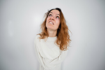 Close-up portrait of insane woman in straitjacket on white background.