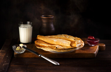 Pancakes, thin pancakes or crepes with jam on a white plate.