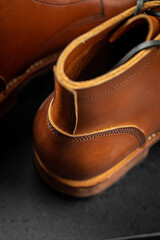 Closeup on handcrafted men's brown leather boots 