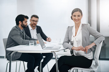 This meeting is a dream. Portrait of an attractive young businesswoman sitting in the boardroom during a meeting.