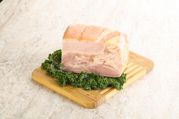 Cut of pork bacon over board