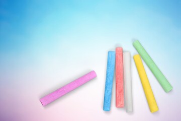 Stack of colored chalk on background