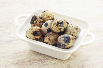 Raw quail eggs heap in the bowl