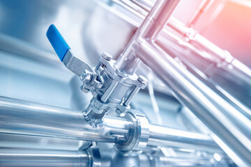 Stainless pipes for food industry for transporting milk, beer. Concept production line, sunlight