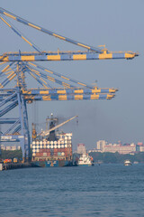 Fototapeta premium A picture of Container ship terminal Unloading and quay crane of container ship at industrial port with shipping container vessel, Maritime cargo freight ship import export business logistic transport