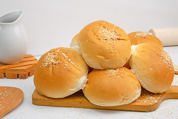 sliced whole bread and small bag with whole wheat flour on textured blue wood, top view.