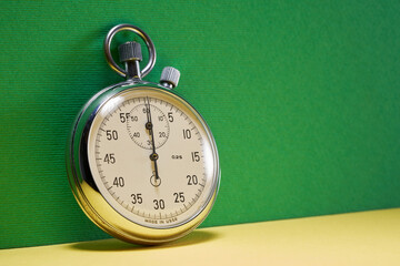 stopwatch against green color background with copy space - obrazy, fototapety, plakaty