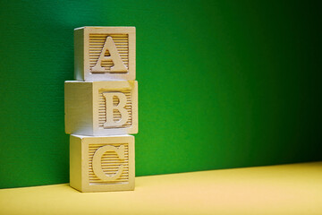 wood block letter a b c against green background