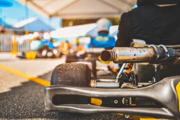 Kart racing park is the starting point for a team of racers at a blurred background.