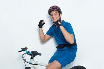 young asian man cyclist shaking fists isolated on white background
