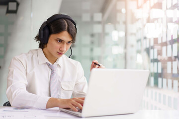 Business concept, Businessman wearing headphone to explain planning with team on video conference