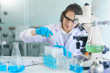 Fototapeta premium Laboratory research concept, Scientist pour solution into test tube to research of vaccine and drug