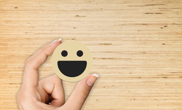 Customer putting smile face emoticon for rating. Service rating, feedback, satisfaction concept