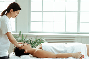 Young woman making massage at spa center