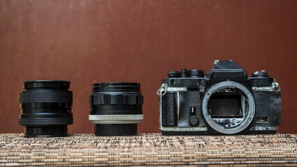 Collection of old camera and lens with brown background	